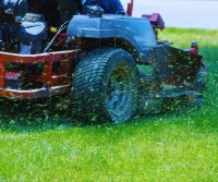 Ride-on lawn mower in action, provided by P&R Mowing for efficient lawn mowing services in Saint John